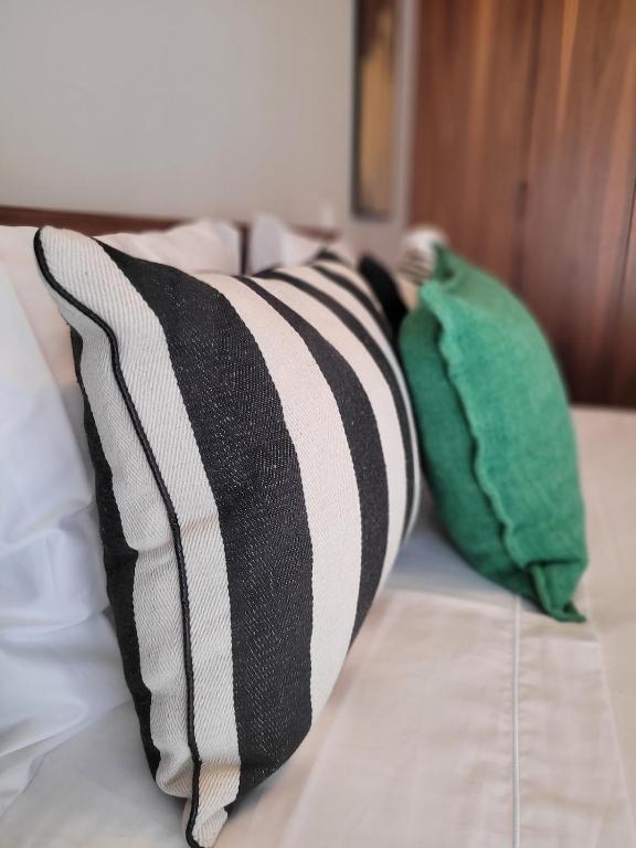 two pillows sitting on top of a bed at Mouzinho50 - Elegant Apartment in Póvoa de Varzim
