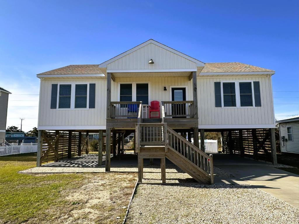 a large white house with a wooden deck at KD1730 - Cole's Cabana in Kill Devil Hills