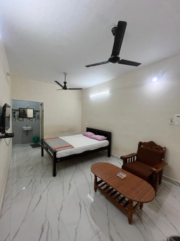 a room with a bed and a couch and a table at Gravity Groups AARA Residency - Near Jipmer in Puducherry Airpoert
