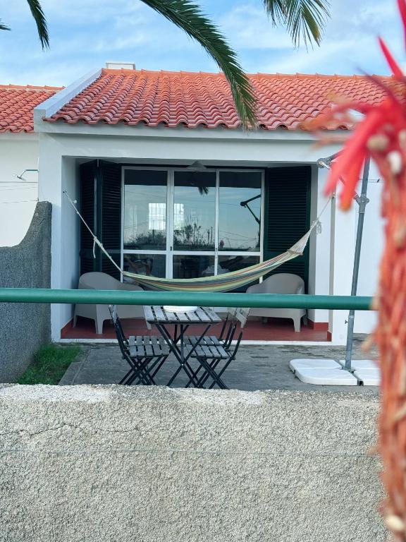 a hammock in front of a house at Casa do Profeta in Porto Santo