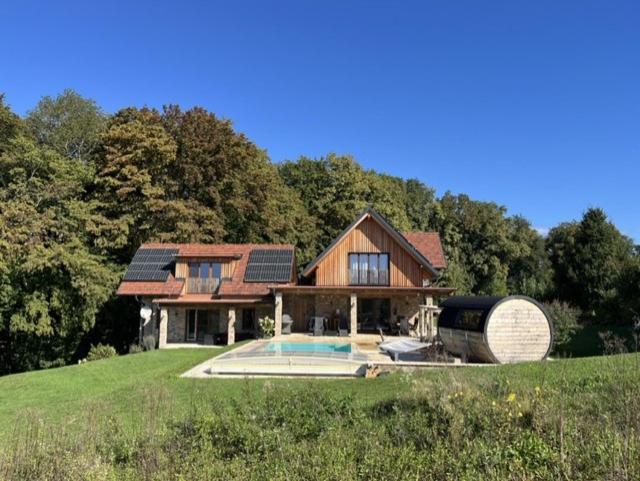 a house with a swimming pool in the yard at Landvilla Sinelia premium in Dietersdorf am Gnasbach