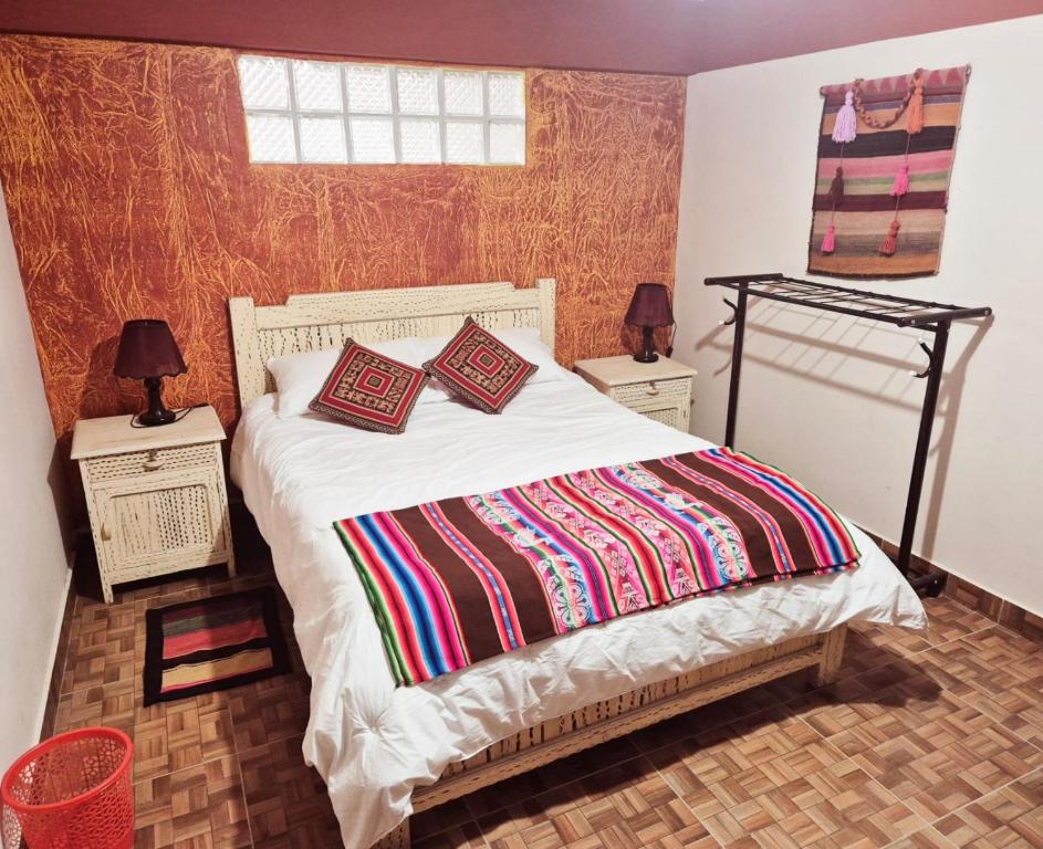 a bed with two pillows on it in a bedroom at Hotel Aguilar in Uyuni