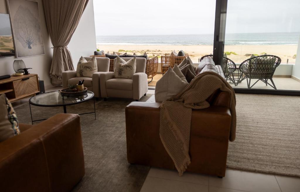 a living room with a view of the beach at Oceana View at Oceans 3 Selfcatering Holiday Home in Rand Rifles