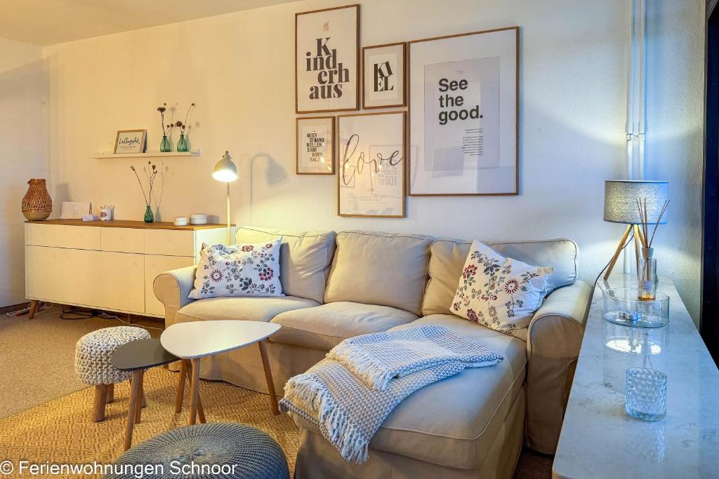a living room with a couch and a table at Luv und Lee in Schilksee