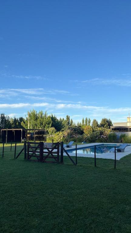 a picnic table in the grass next to a body of water at Finca los Cauquenes Chascomus in Chascomús
