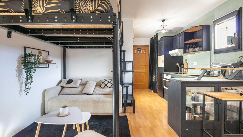 a living room and kitchen with a bunk bed at Le Birdie NI105 - ST2 in Giez