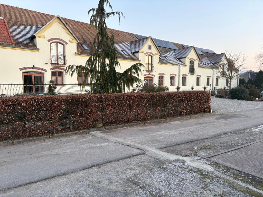 a large white house with a fence in front of it at Agroturystyka Maya in Gorzyca