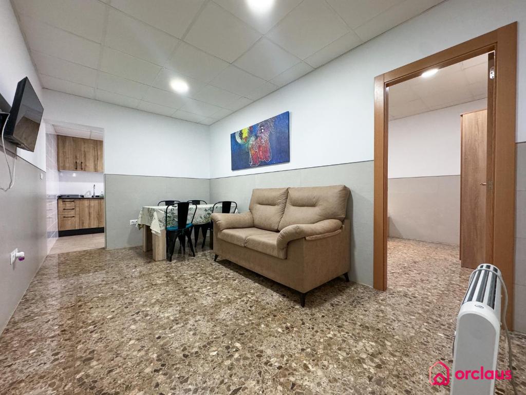 a living room with a couch in a room at El Piso Bajo in San Juan de Moró