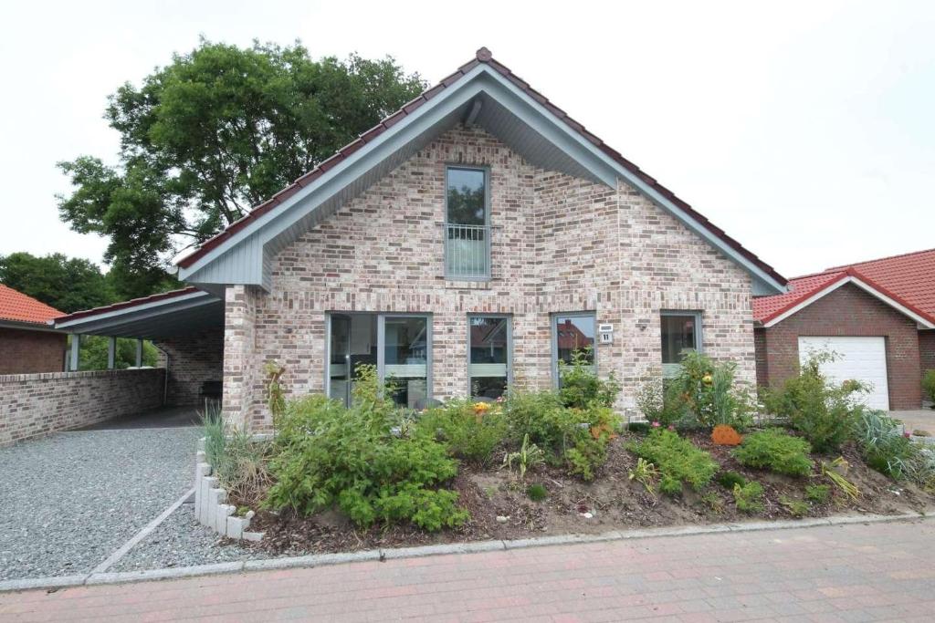 a brick house with plants in front of it at Feriendorf Südstrand Haus 11 in Pelzerhaken