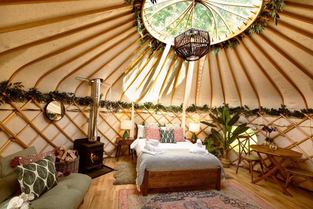 a room with a bed in a yurt at Hazel Tree Yurt - Eavestone Lake in Grantley