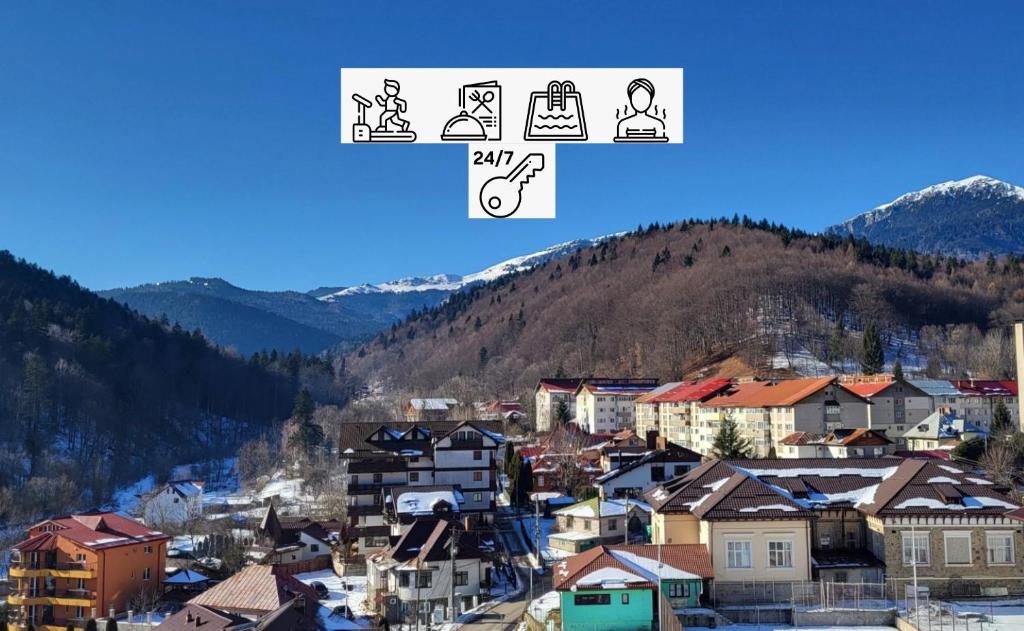a city with a mountain in the background at Perla Sinaia in Sinaia