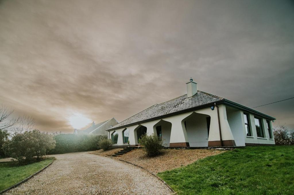 a small white chapel with a cross on the roof at Mullaghmore Holiday Home in Cliffony