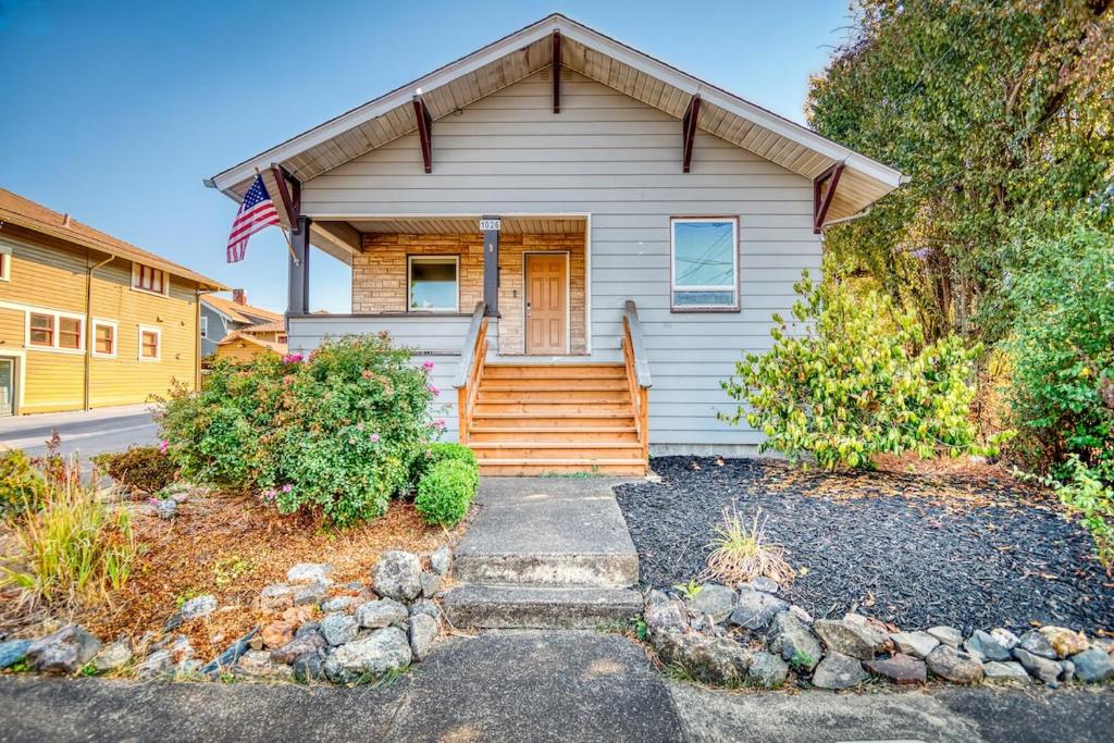 a house with a flag on the front of it at La Maison - Elegant 2BR Escape - Free Breakfast! in Albany
