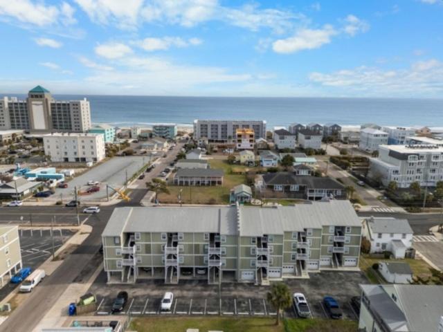 an aerial view of a city with the ocean at Sea The Good condo in Carolina Beach