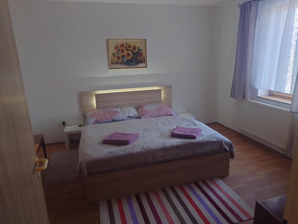 a bedroom with a bed with purple pillows on it at Zukalka 2KK - 2 in Ostrava
