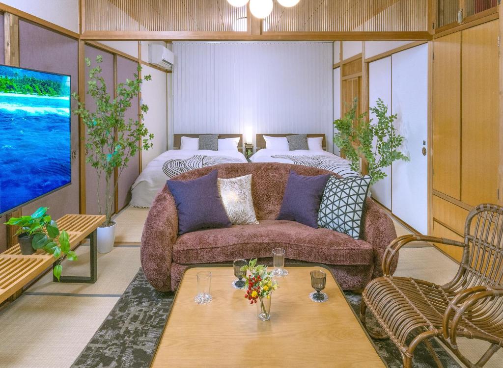 a living room with a couch and a bed at Kawaramachi Grande Joy in Takamatsu