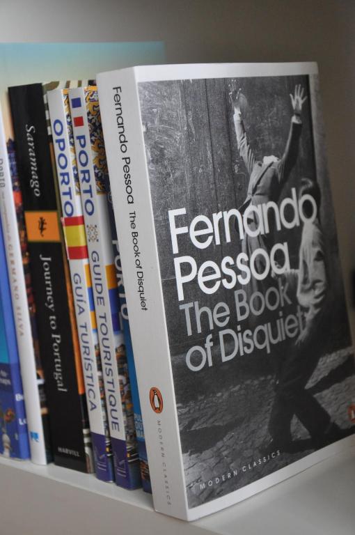 a book sitting on top of a shelf with books at PicPorto Apartment in Porto