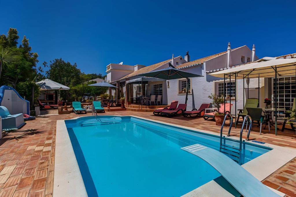 a swimming pool in front of a house at Quinta Velha by GT House in Portimão