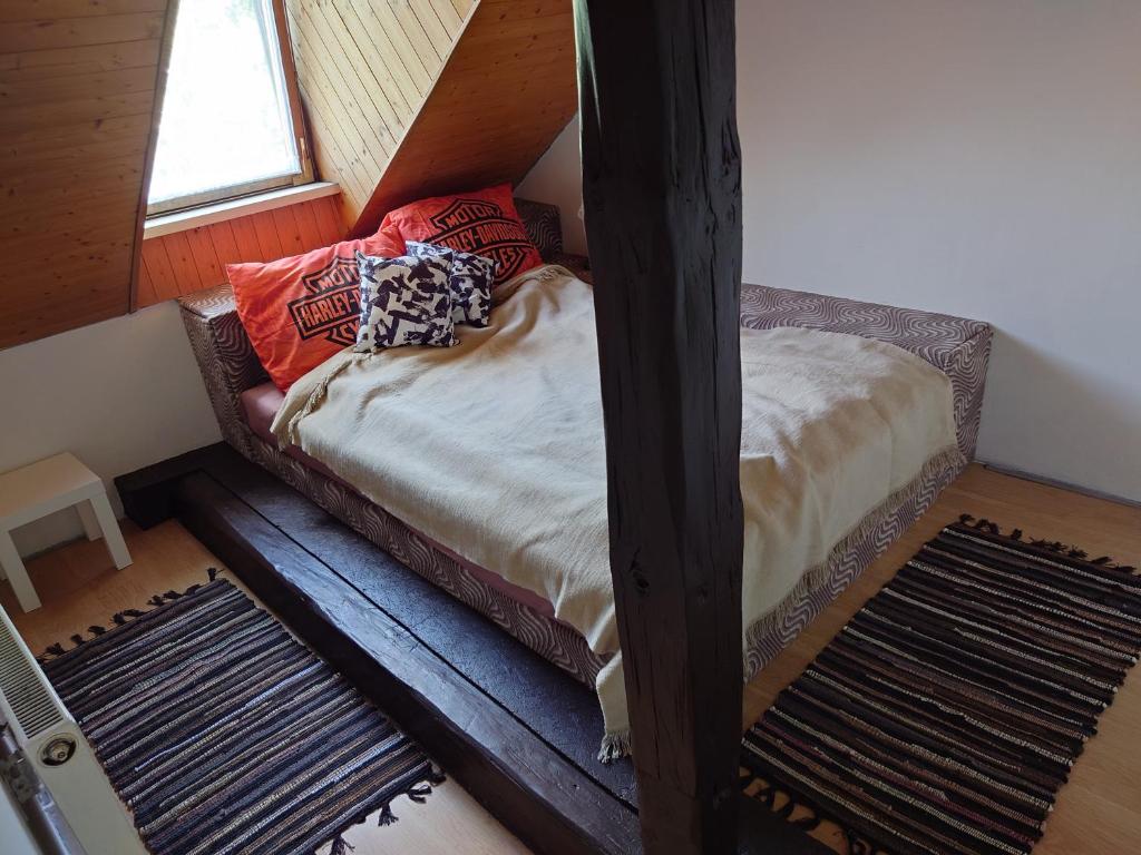 a bed with pillows on it in a room at Zukalka 2KK - 3 in Ostrava