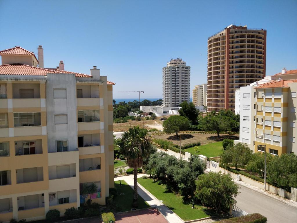 a view of buildings and trees in a city at Buzios Praia da Rocha in Portimão
