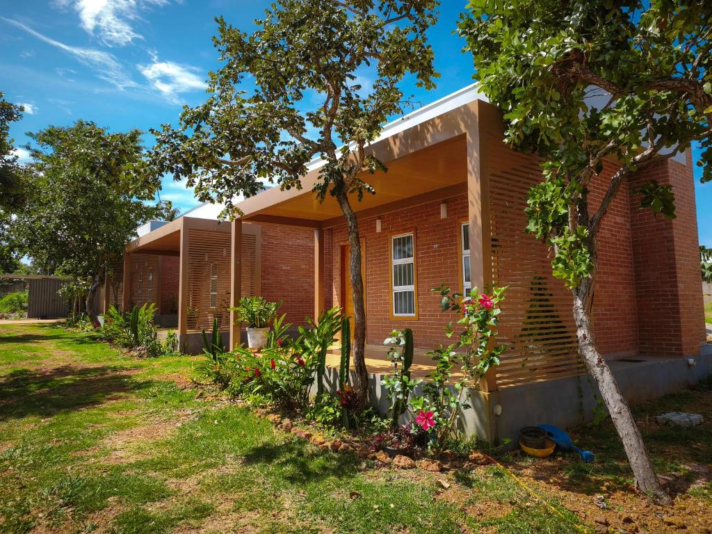 a brick house with a yard at ChapadaFlats in Chapada dos Guimarães