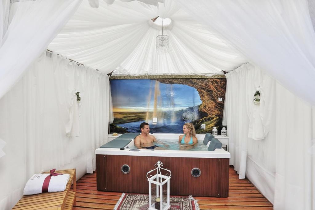 two people in a bath tub in a tent at La Suite Toscana in Certaldo