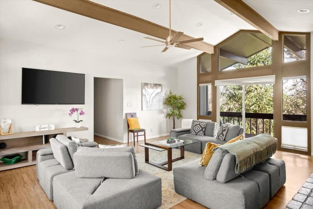 a living room with two couches and a flat screen tv at High Country Rretreat in Flagstaff