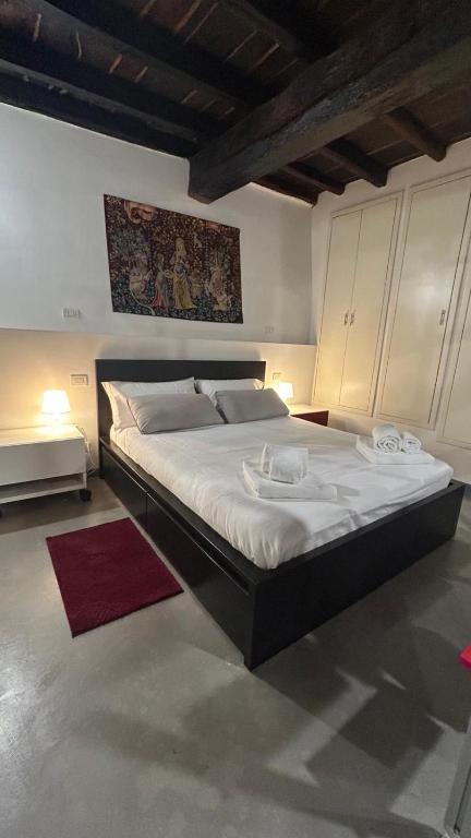 a bedroom with a large bed with white sheets at Casa in Piazzetta in Zagarolo