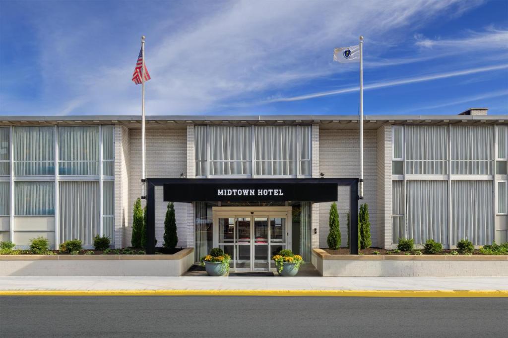 a hotel with an american flag in front of it at The Midtown Hotel MOD Collection by Sonesta in Boston