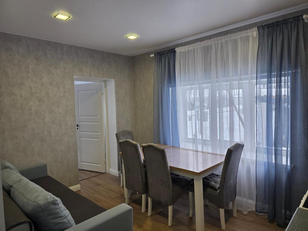 a dining room with a table and chairs at Mustvee aparts in Mustvee