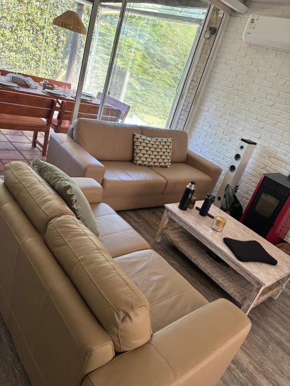 a living room with a couch and a table at Casa en Complejo Sierra Alta in Punta del Este