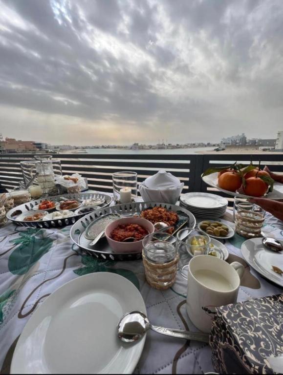 a table with plates of food on a balcony at Luxury B3 Chalet COMO in Al Khīrān
