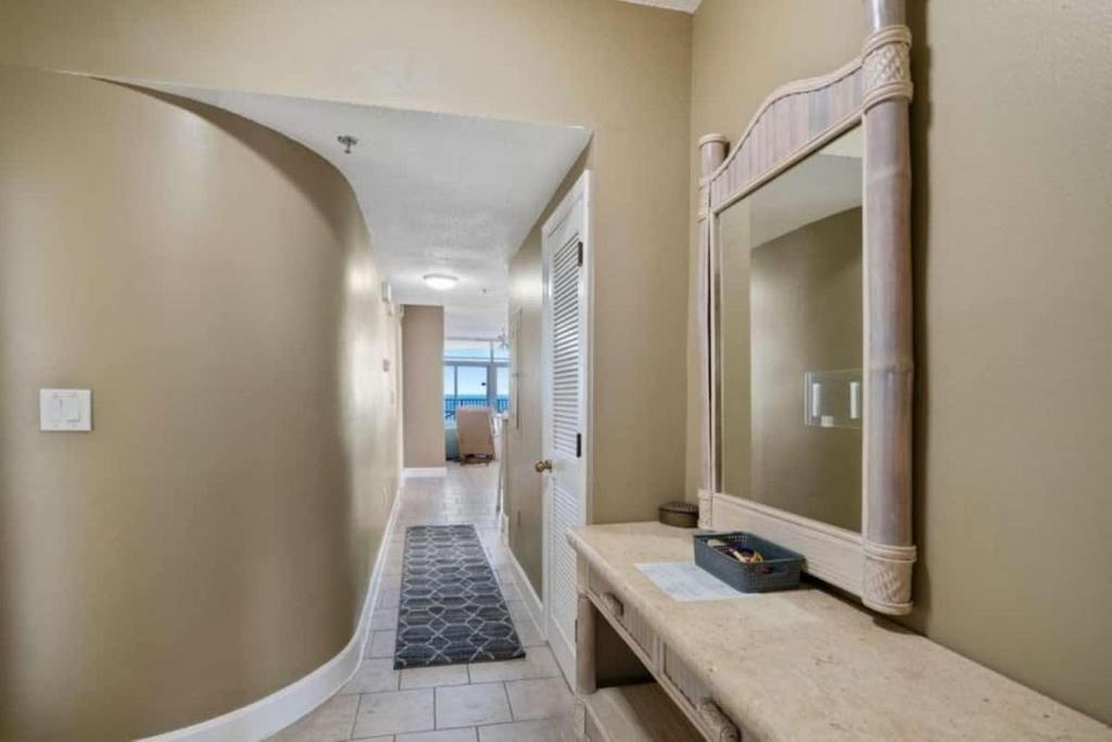a hallway with a large mirror on the wall at Jade East Towers 1850 in Destin