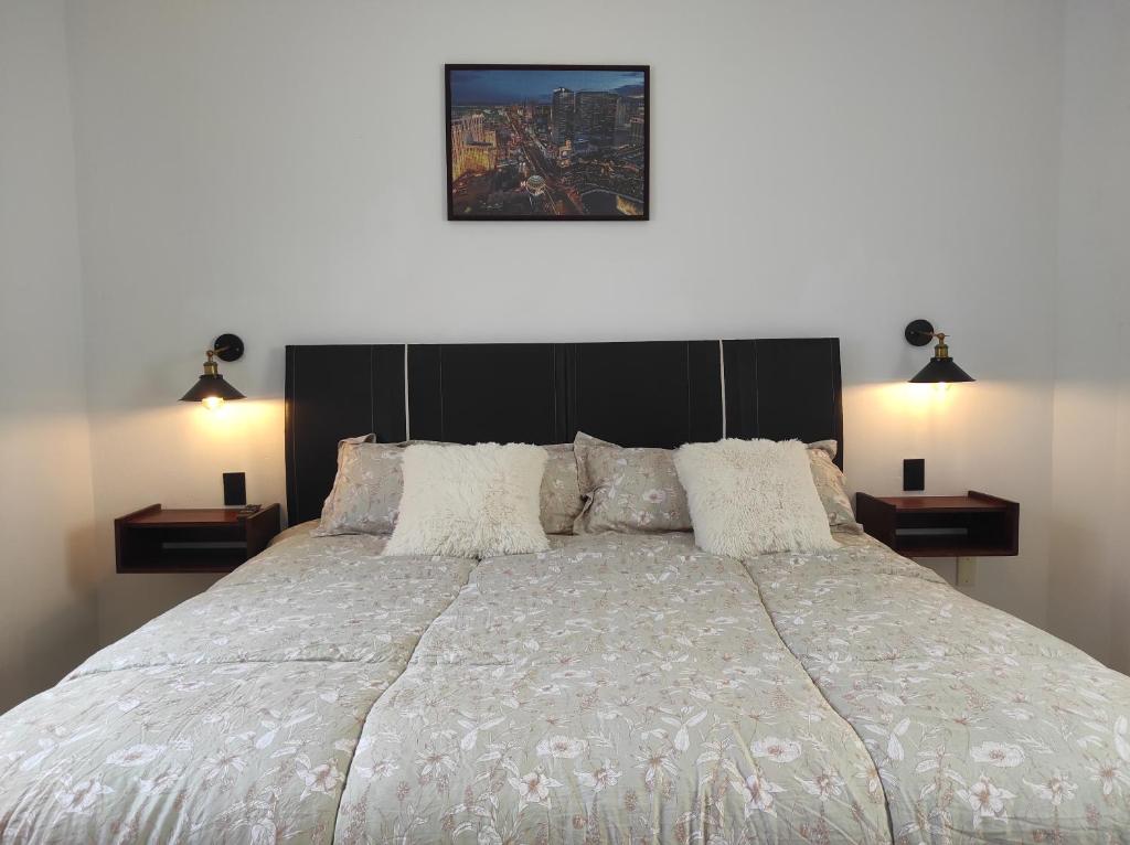 a bedroom with a large bed with two night stands at Departamento Privado in Guadalajara