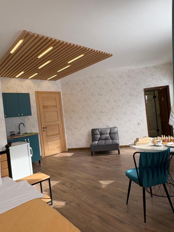 a living room with a table and a couch at Apart-Hotel Seti in Mestia