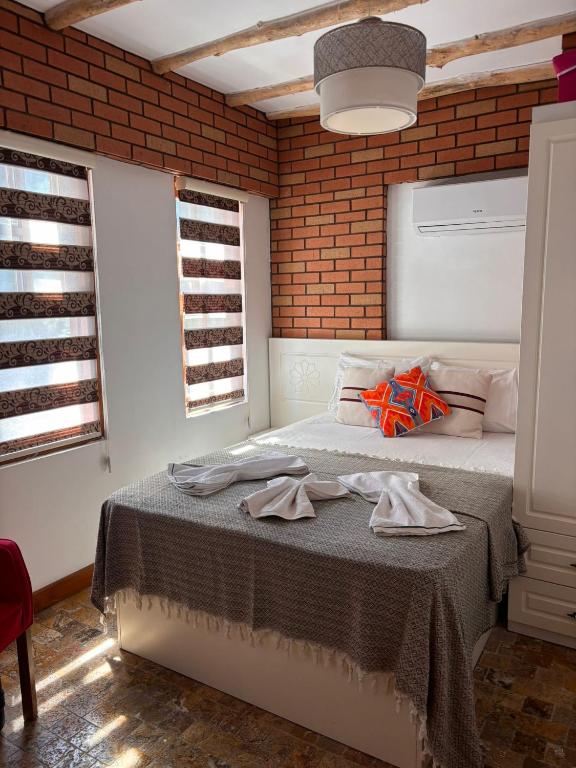 a bedroom with a bed with towels on it at BAT Apart Otel in Antalya