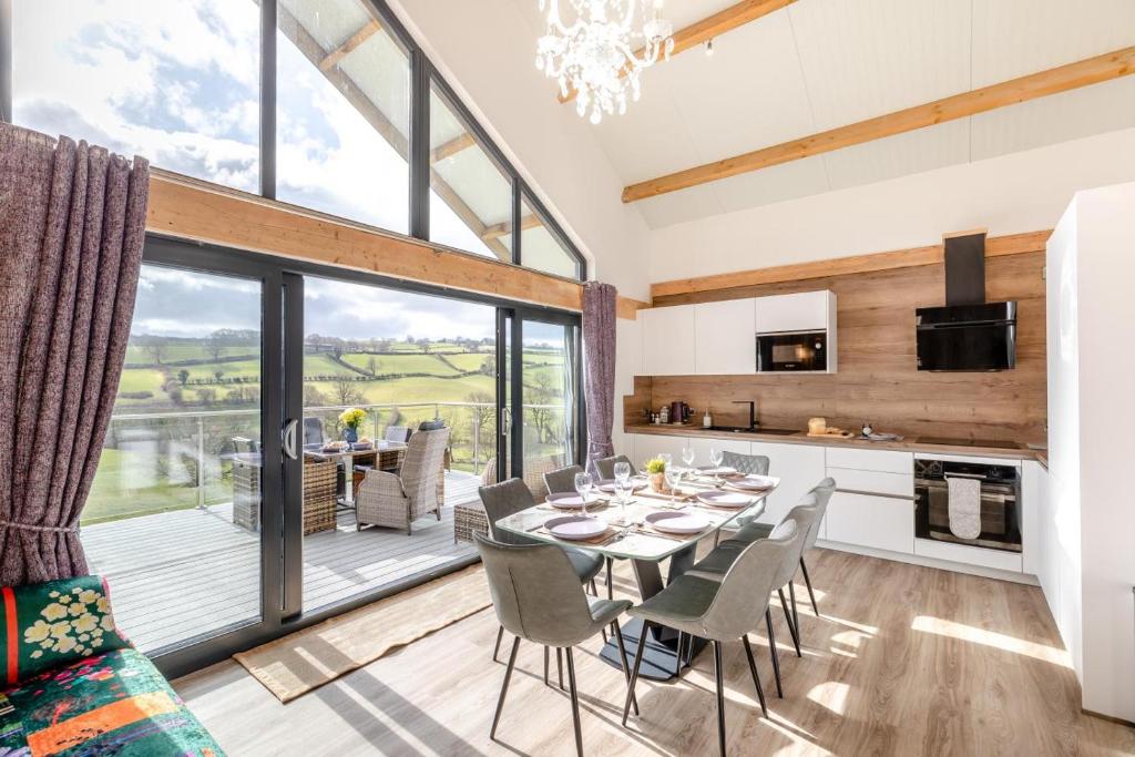 a kitchen and dining room with a table and chairs at 4 Bed in Berriew oc-t31114 in Berriew