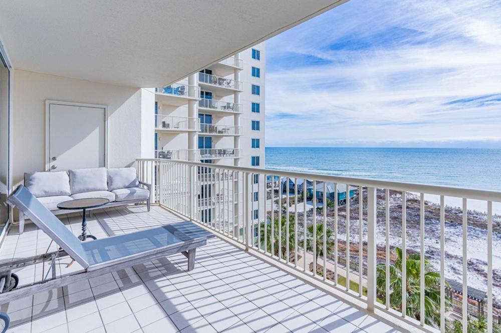 a balcony with a couch and a view of the ocean at Beach Club 806A by Youngs Suncoast in Gulf Highlands