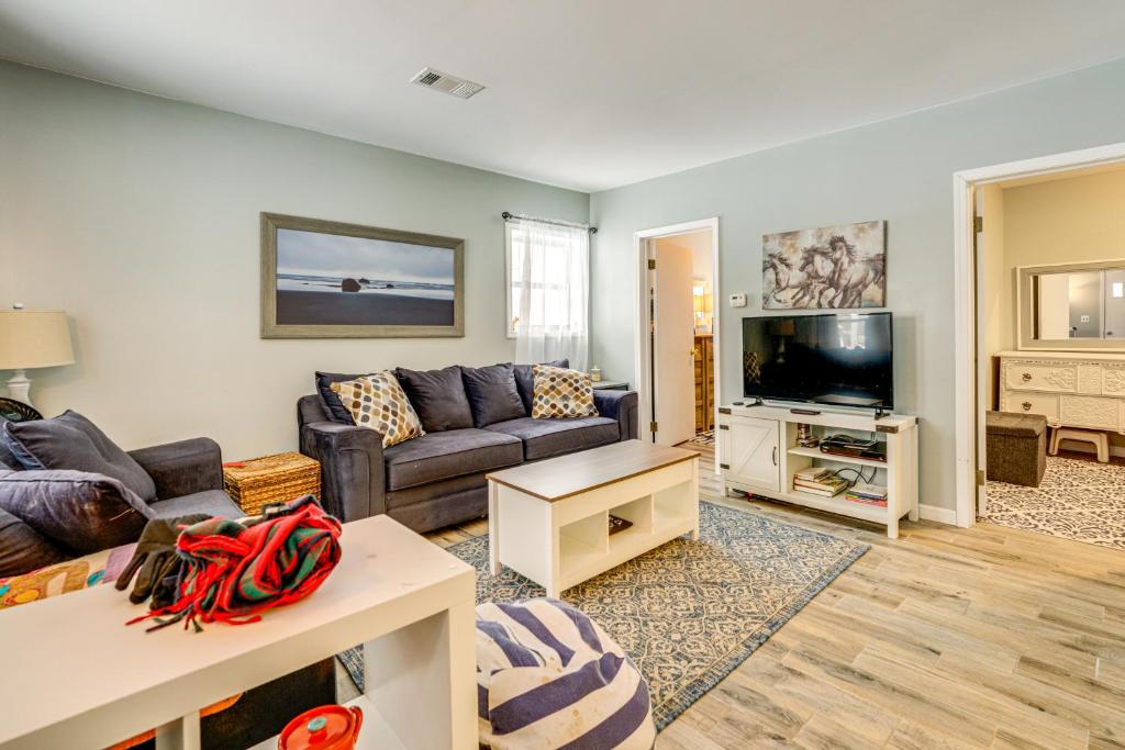 a living room with a couch and a tv at Woodsy & Charming! Applegate Cabin w/ Large Yard in Applegate