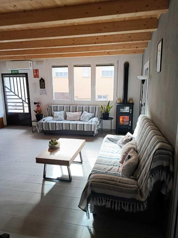 a living room with a couch and a table at Casa Rural El Capricho in Casas del Monte
