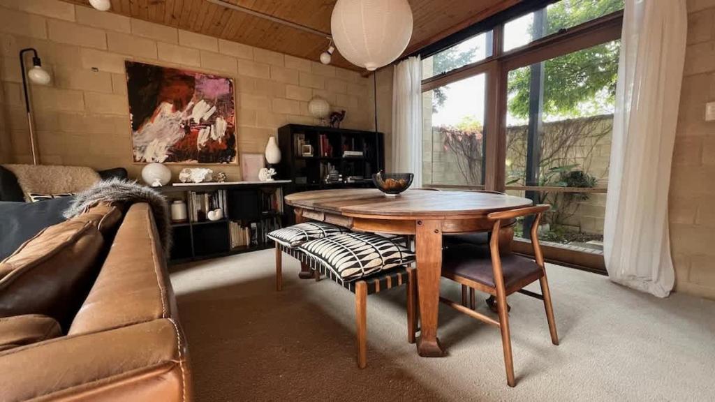 a living room with a table and a couch at Architectural Gem in Geelong in Geelong