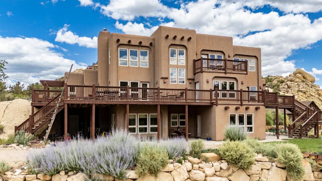 a large house with a balcony on a mountain at Slot Canyons Inn Bed & Breakfast in Escalante