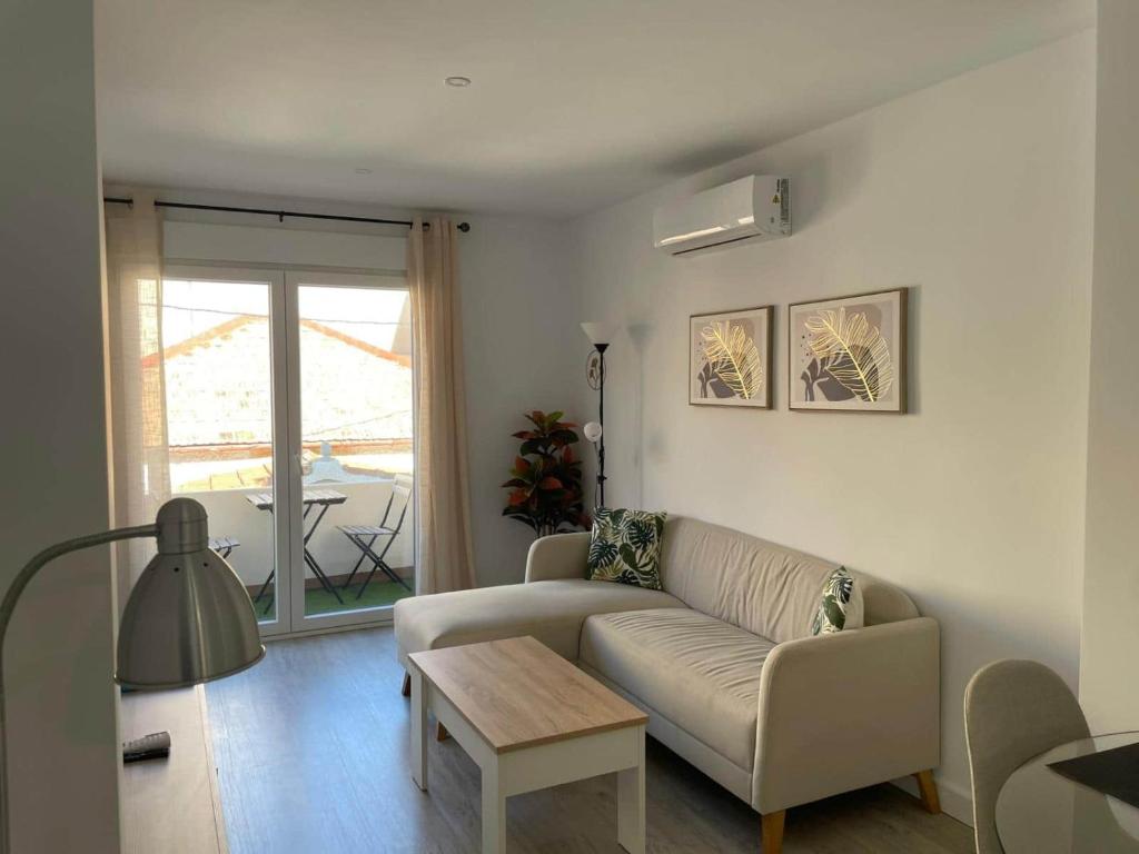 a living room with a couch and a table at Modern Apartment Near Golf, Beach & Marina in San Pedro del Pinatar