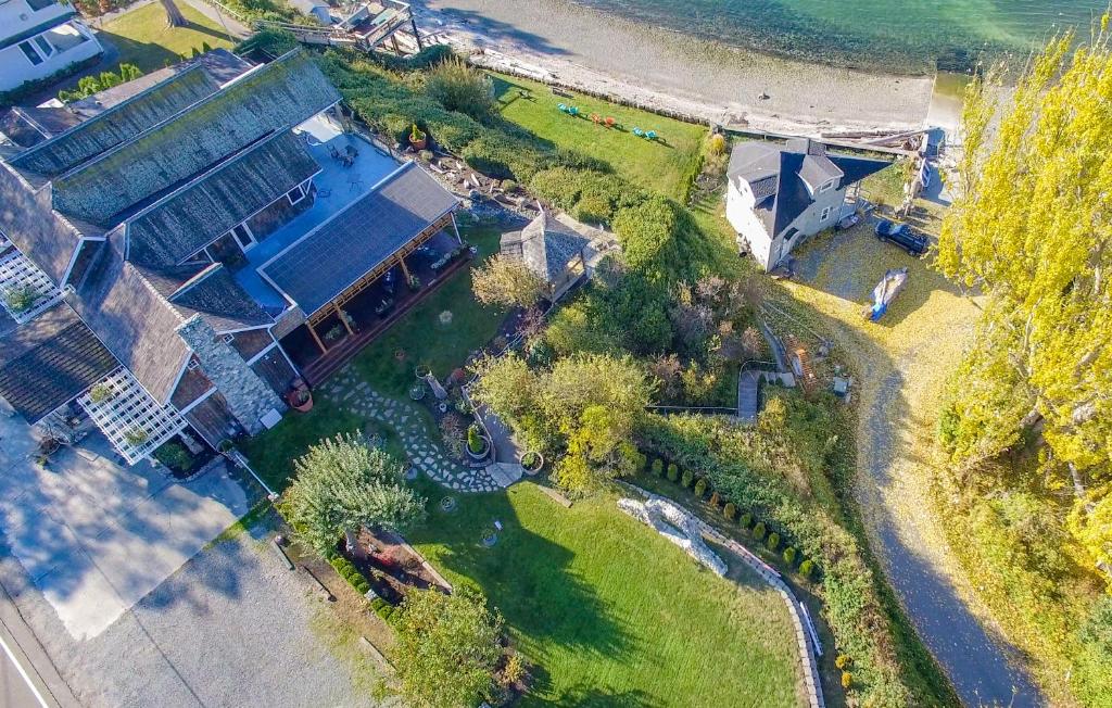 an aerial view of a house next to the ocean at Camano Island Inn in Camano