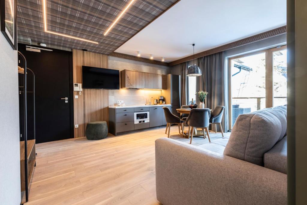 a kitchen and living room with a couch and a table at Gerlach in Zakopane