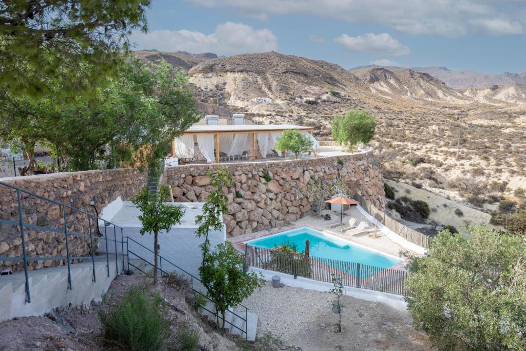 a villa with a swimming pool in the desert at Casa Ubedas in Almería