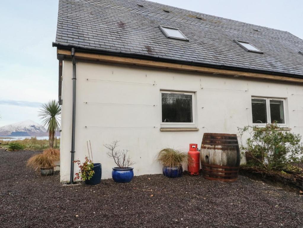 a white house with plants in front of it at Sealladh in Appin