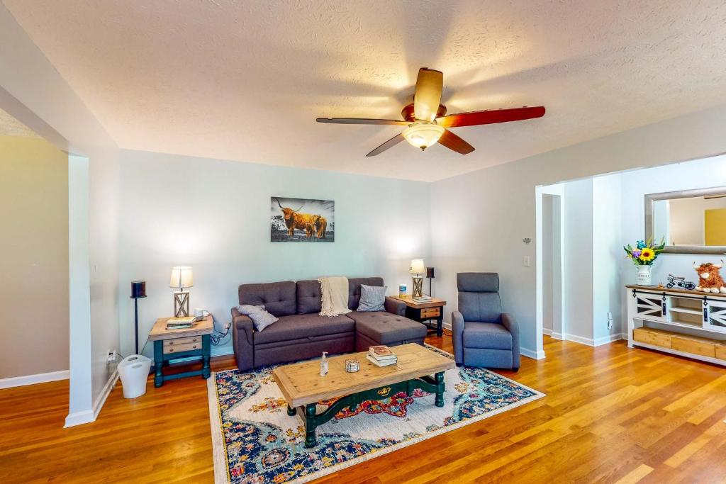 a living room with a couch and a ceiling fan at Danielsville Home on Sprawling Acreage w/ Views! in Commerce