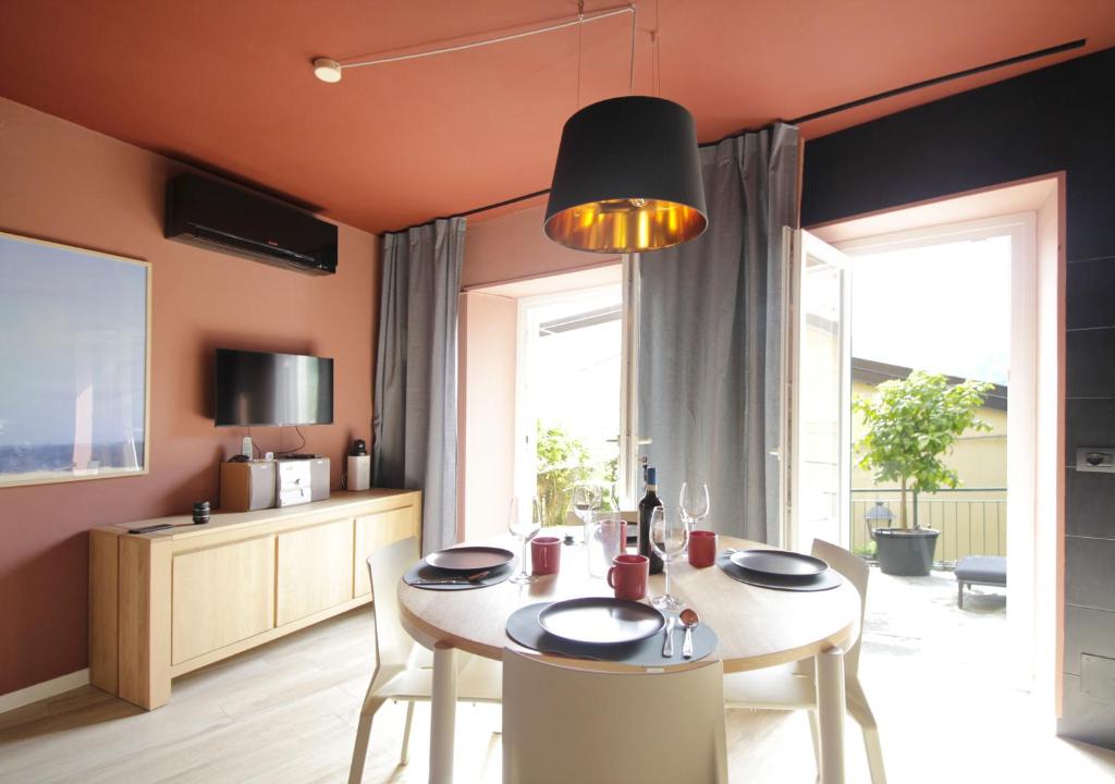 a kitchen and dining room with a table and chairs at Milk River - beach front, railway station, lake view in Varenna
