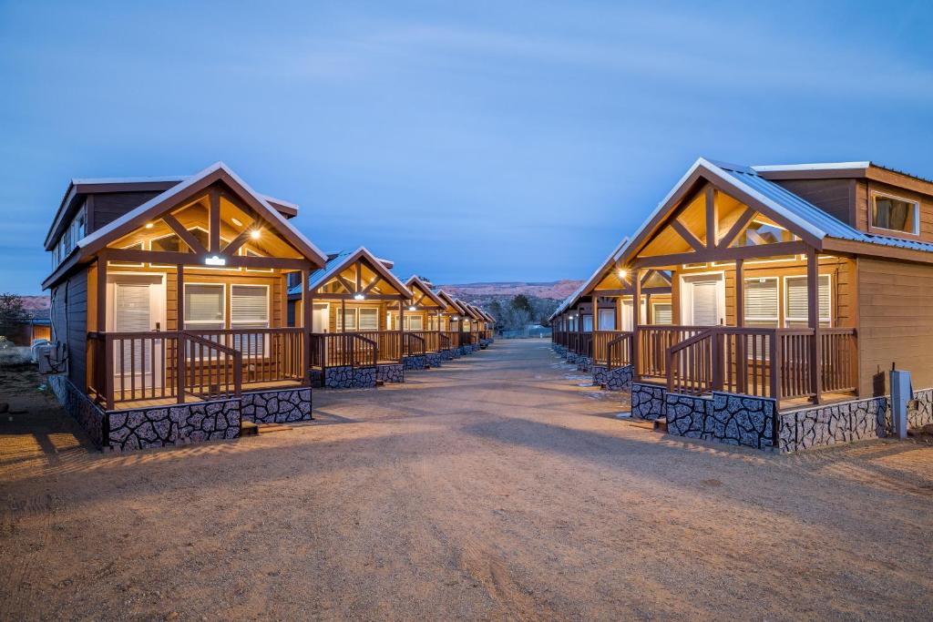 a row of log cabins at a resort at Arches Hut in Moab